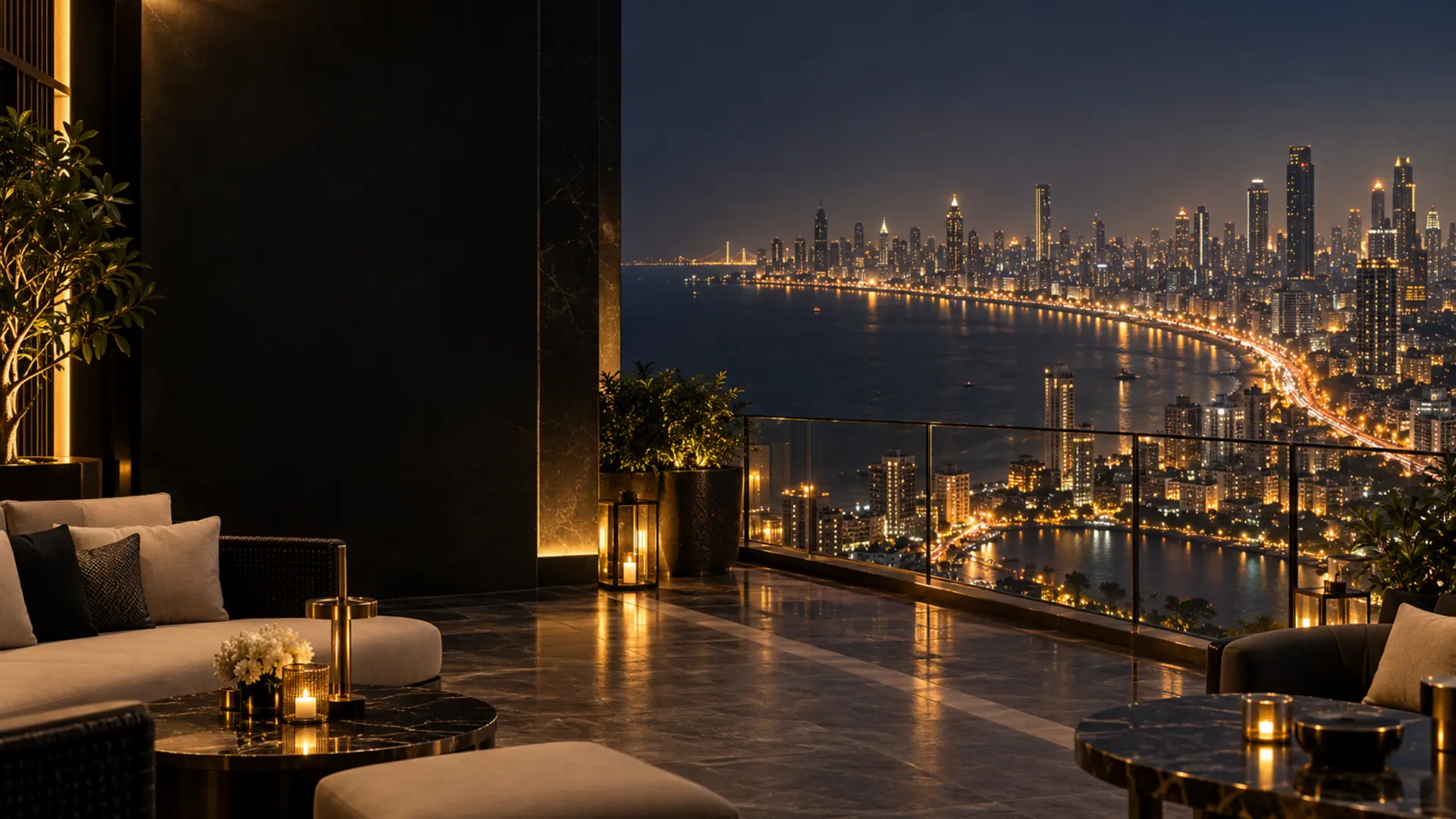 Luxury terrace overlooking Mumbai's illuminated skyline and curving coastline at night